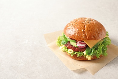 Photo of Tasty vegetarian burger with beet cutlet on light background. Space for text