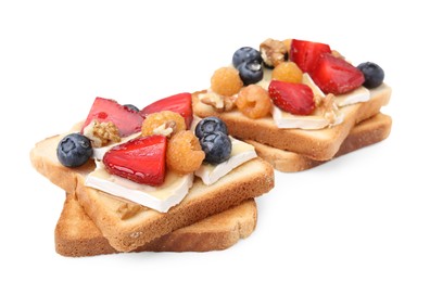 Photo of Tasty sandwiches with brie cheese, fresh berries and walnuts isolated on white