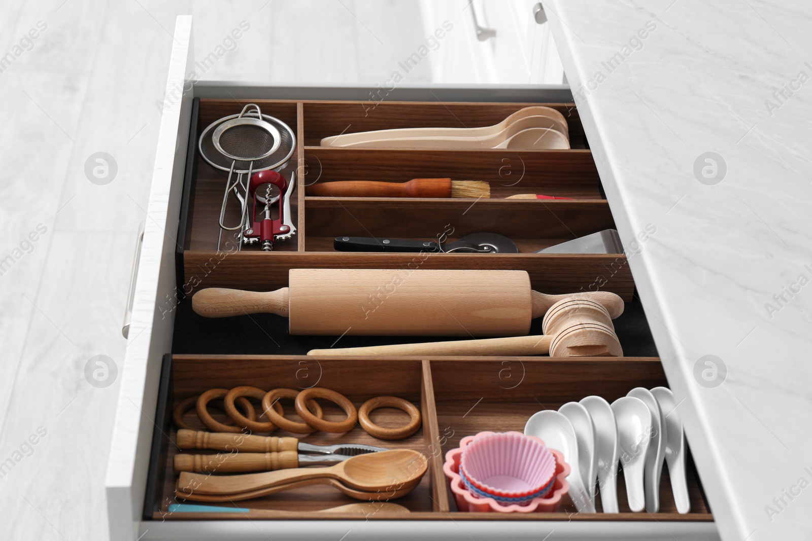 Photo of Drawer with utensil set, closeup. Order in kitchen