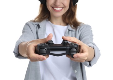 Photo of Smiling woman in headphones playing video game with controller on white background, closeup