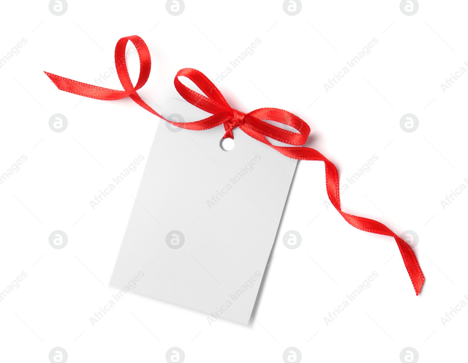 Photo of Blank gift tag with satin ribbon on white background, top view