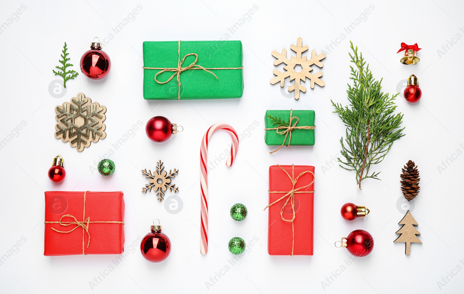 Photo of Flat lay composition with Christmas gifts and festive decor on white background