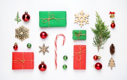 Flat lay composition with Christmas gifts and festive decor on white background