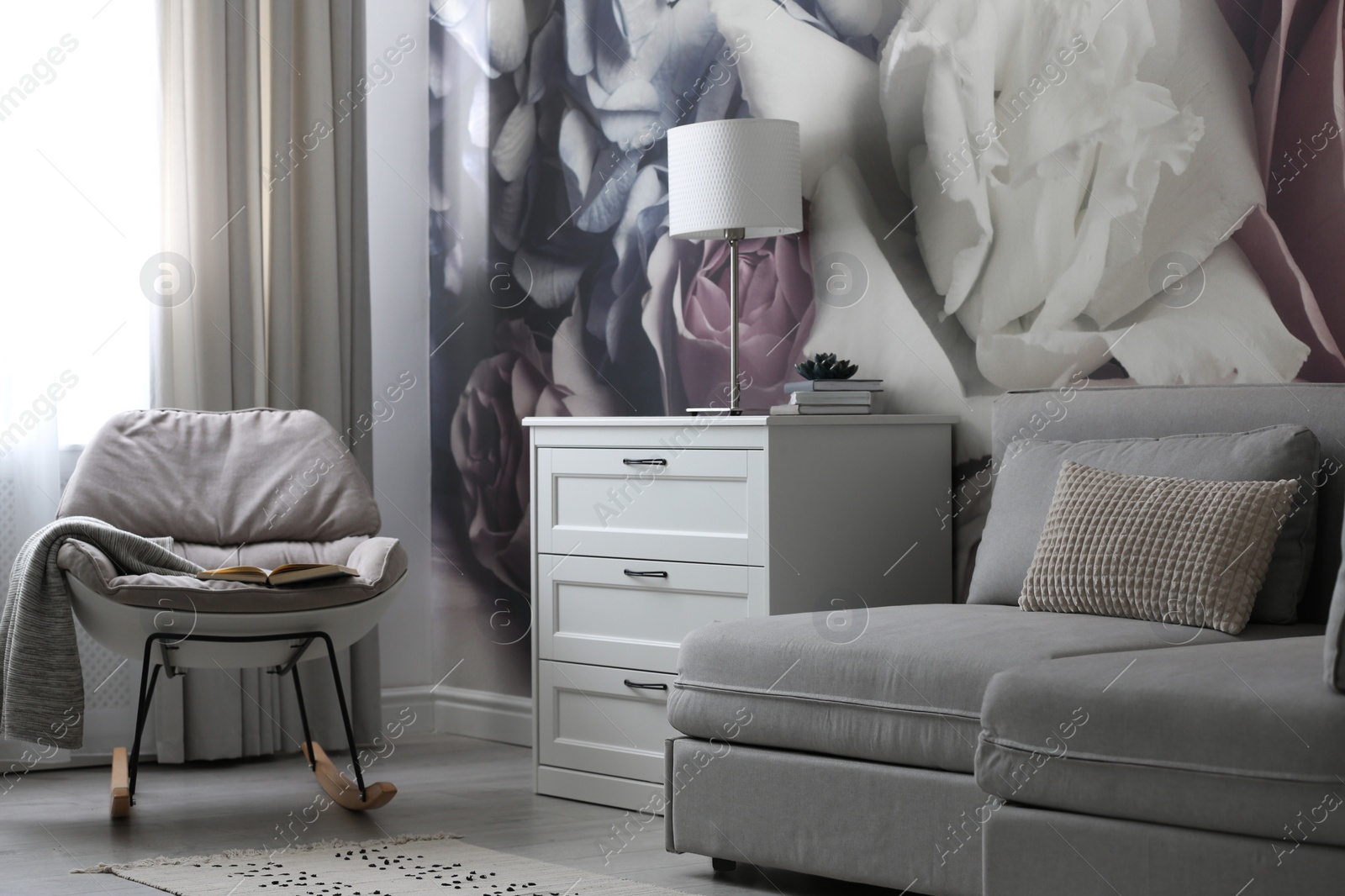 Photo of White chest of drawers in stylish living room. Interior design