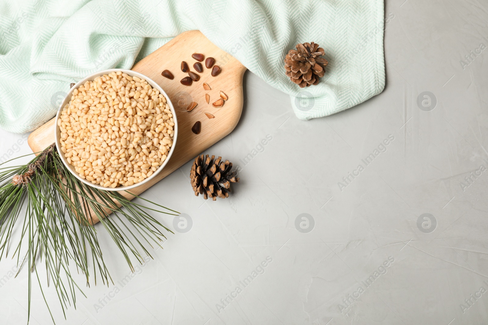 Photo of Flat lay composition with pine nuts on gray background. Space for text