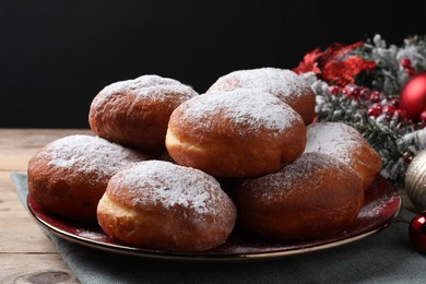 Delicious sweet buns on table against black background, closeup
