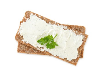 Photo of Fresh rye crispbreads with cream cheese and parsley on white background, top view