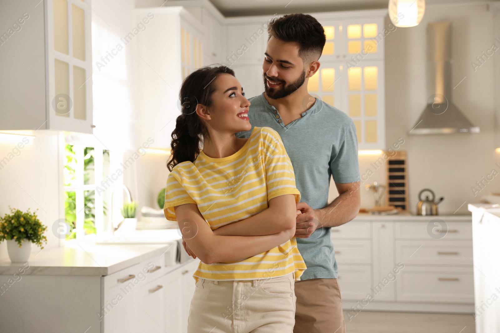 Photo of Lovely young couple dancing in kitchen. Cooking together