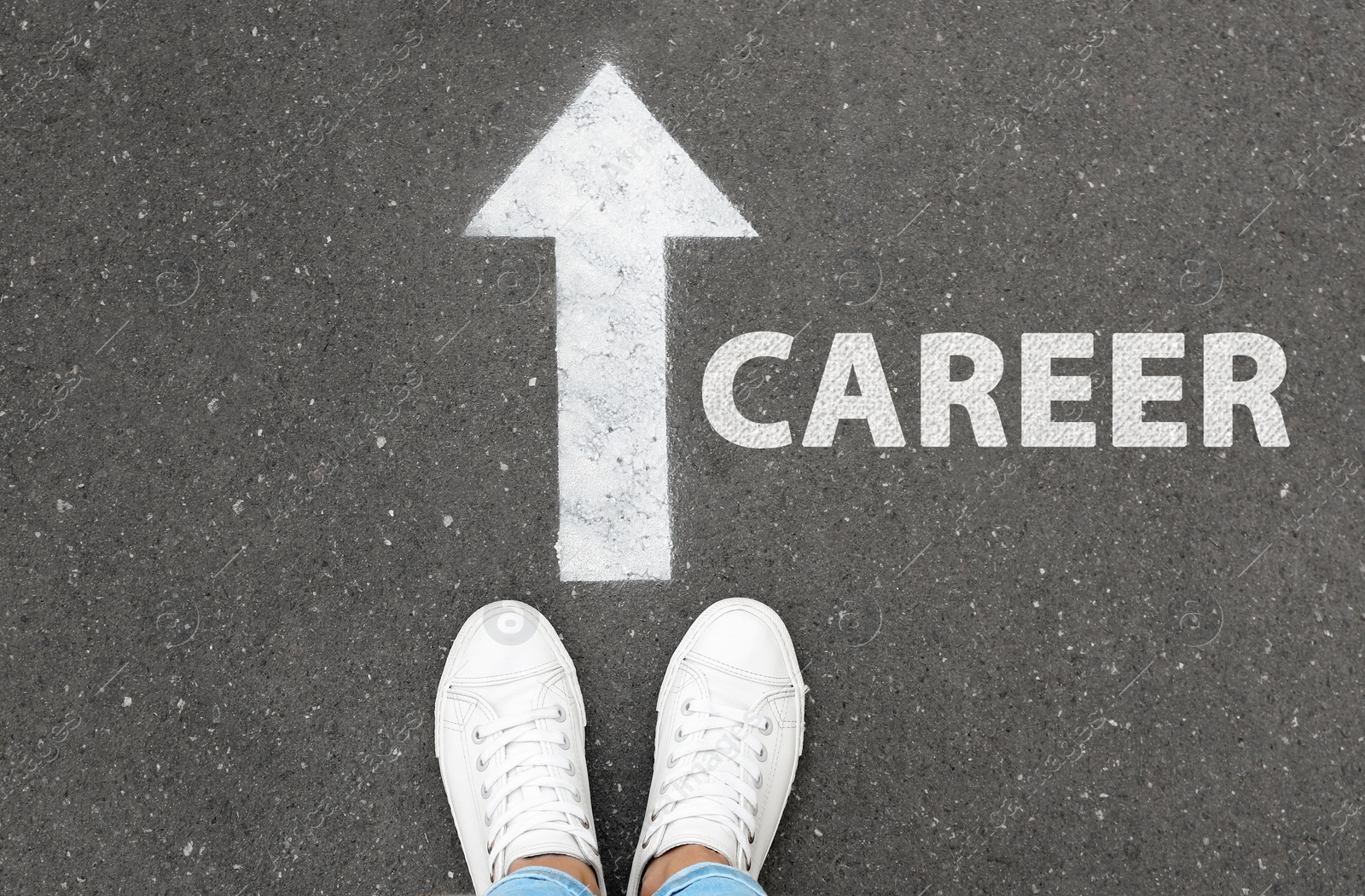 Image of Woman standing near arrow on asphalt, top view. Career choice concept