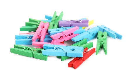 Photo of Pile of colorful wooden clothespins on white background