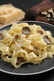 Photo of Tasty tagliatelle with truffle on table, closeup