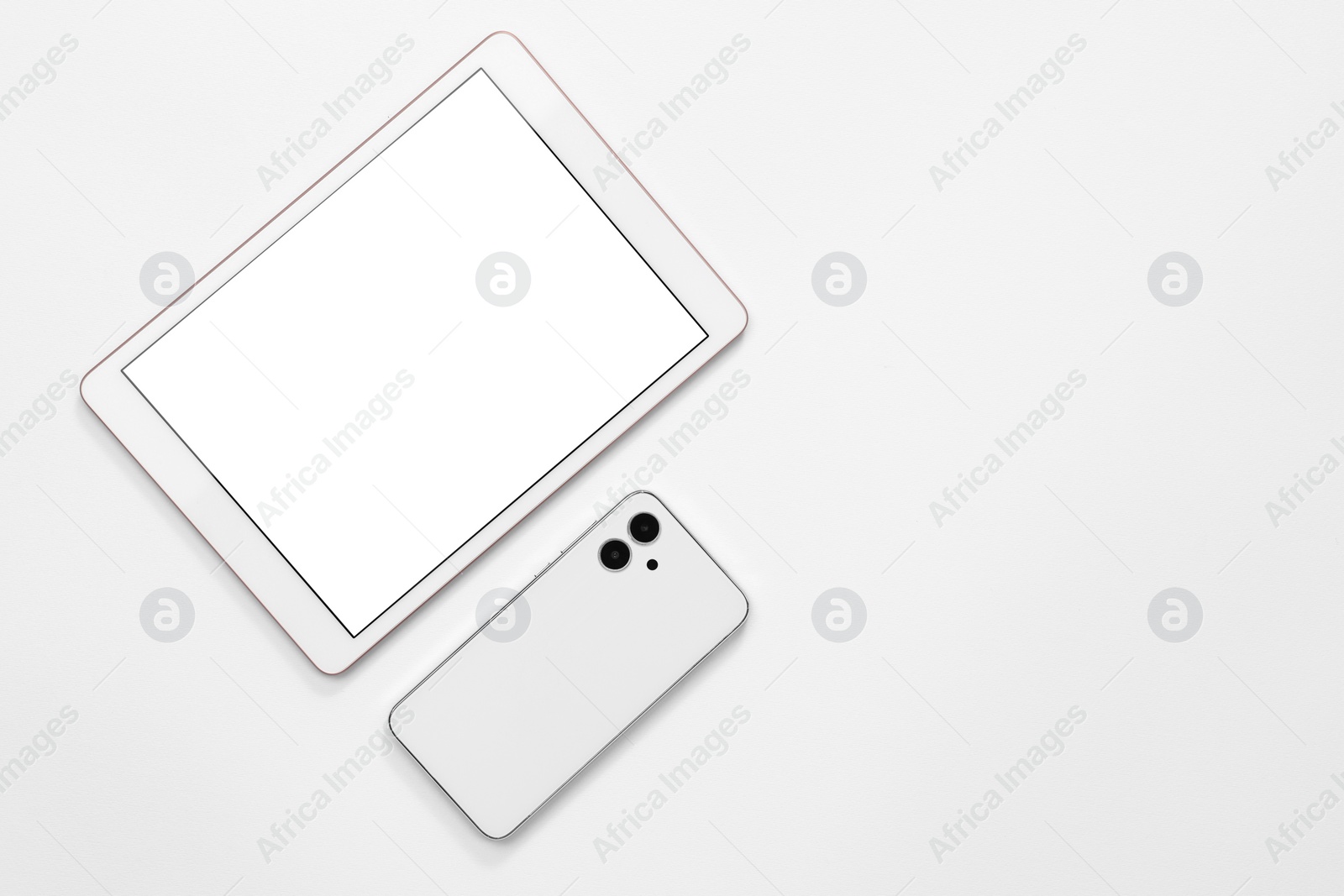 Photo of Modern tablet and smartphone on white background, flat lay. Space for text