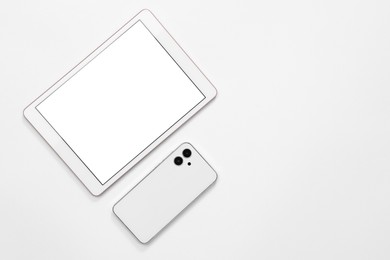 Photo of Modern tablet and smartphone on white background, flat lay. Space for text