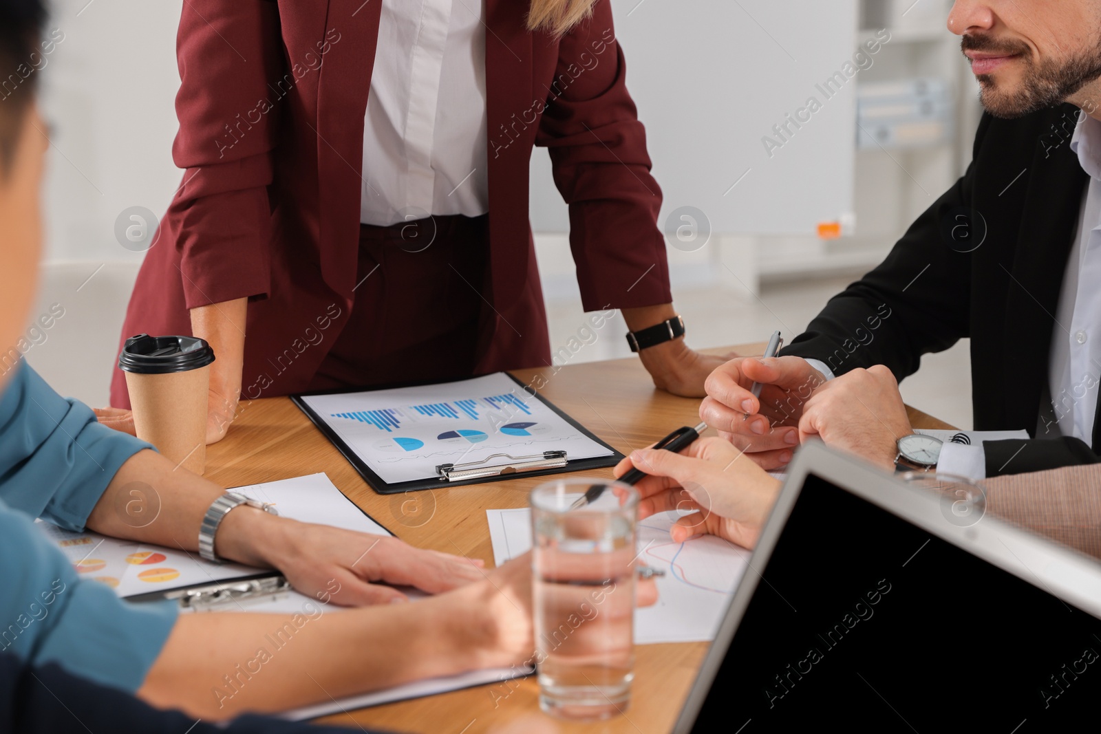 Photo of Businesswoman having meeting with her employees in office, closeup