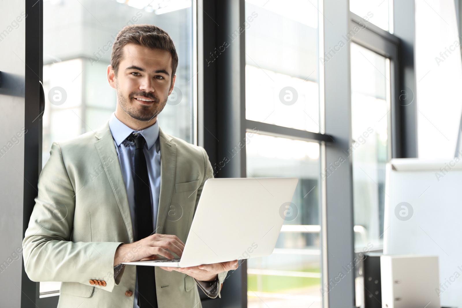 Photo of Male business trainer working with laptop in office