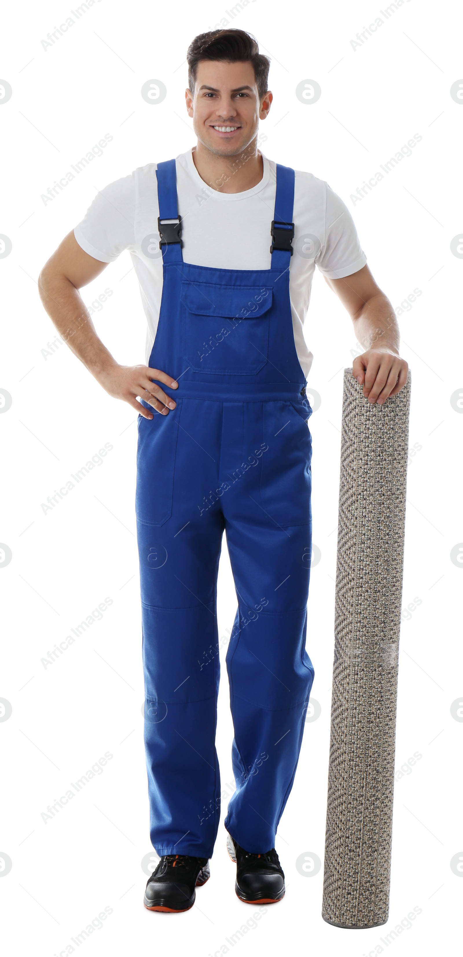 Photo of Male worker with rolled carpet on white background