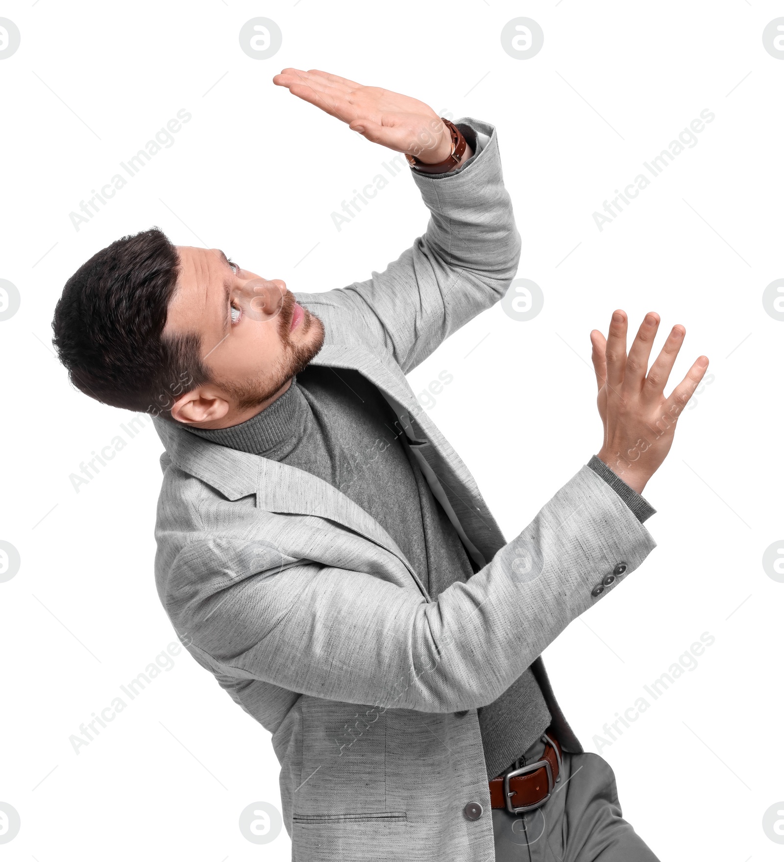 Photo of Handsome bearded businessman in suit avoiding something on white background