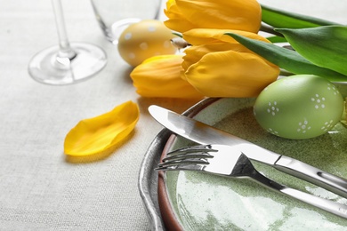 Festive Easter table setting with painted eggs, closeup. Space for text