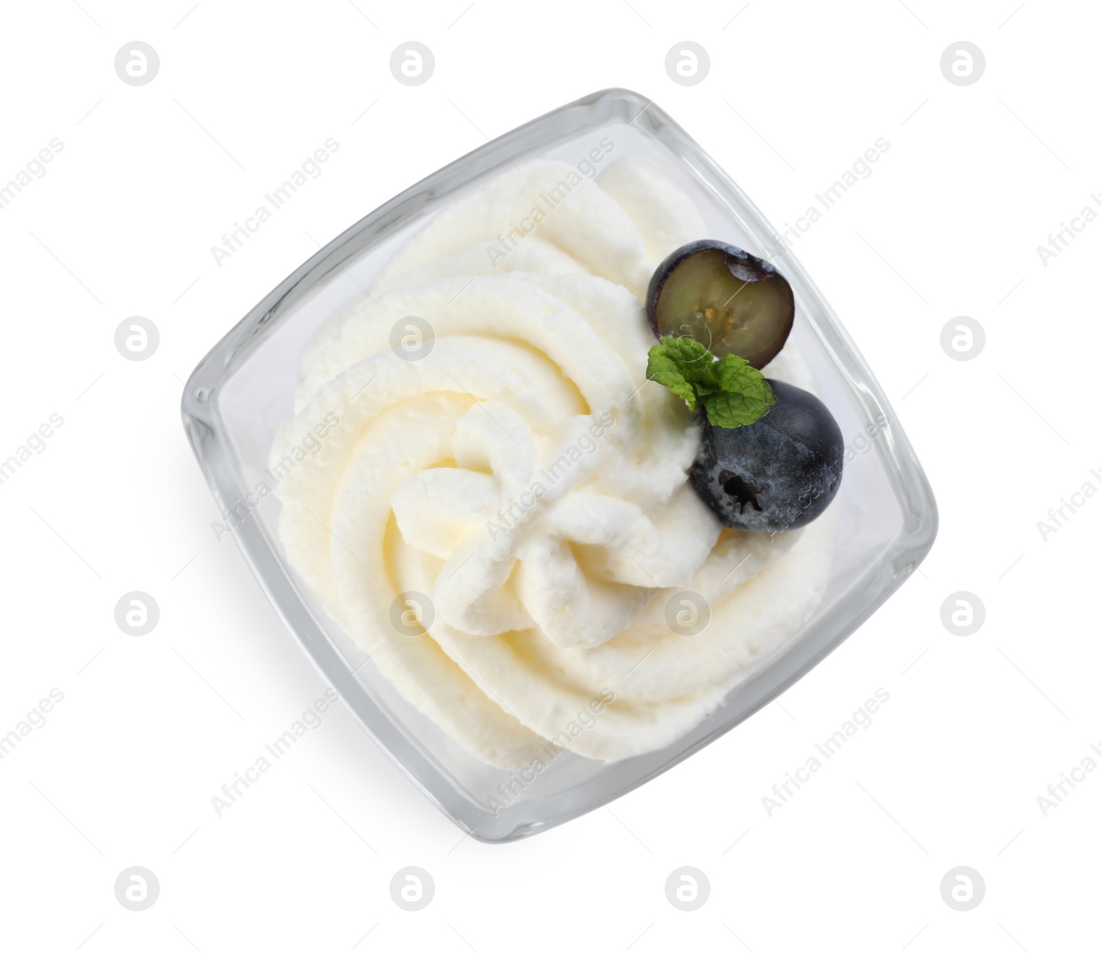 Photo of Delicious fresh whipped cream with blueberries and mint isolated on white, top view