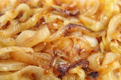 Photo of Tasty fried onion as background, closeup view