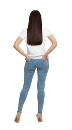 Woman wearing stylish light blue jeans on white background, back view