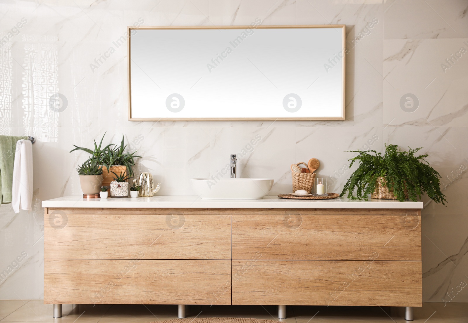 Photo of Stylish bathroom interior with countertop, mirror and houseplants. Design idea