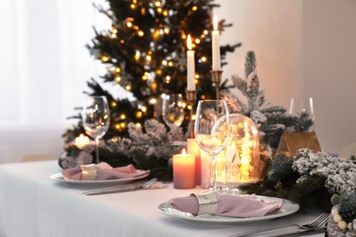 Beautiful festive table setting with Christmas decor in room, space for text