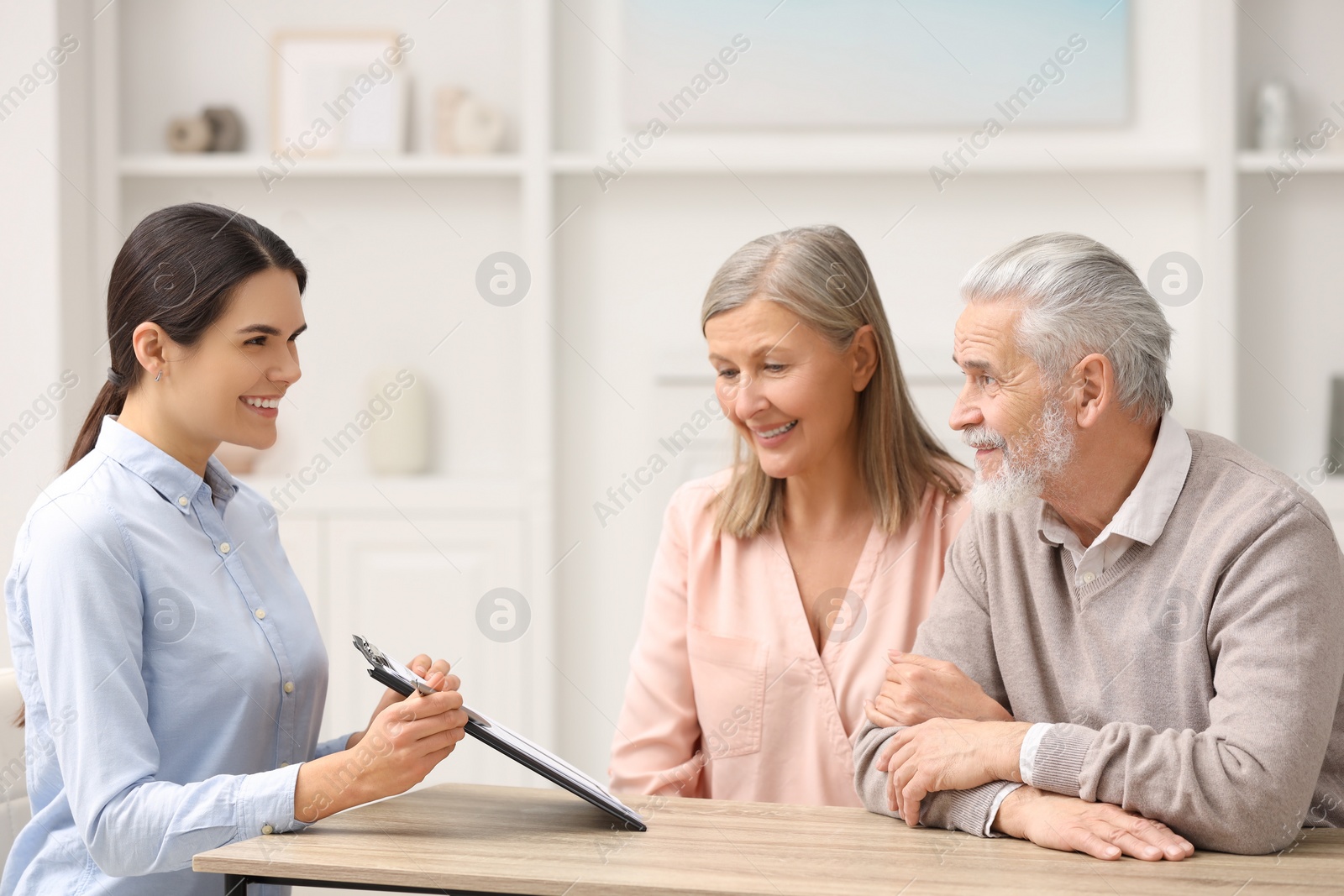 Photo of Notary showing senior couple where to sign Last Will and Testament in office