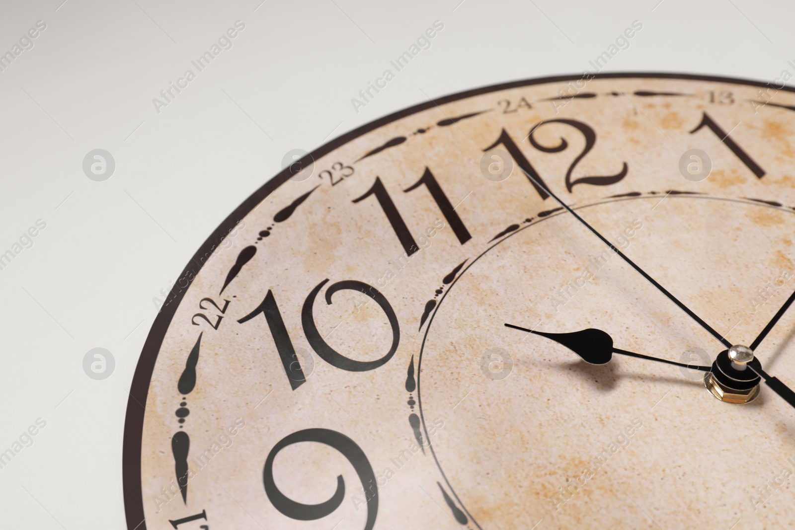 Photo of Stylish round clock on white background, closeup. Interior element