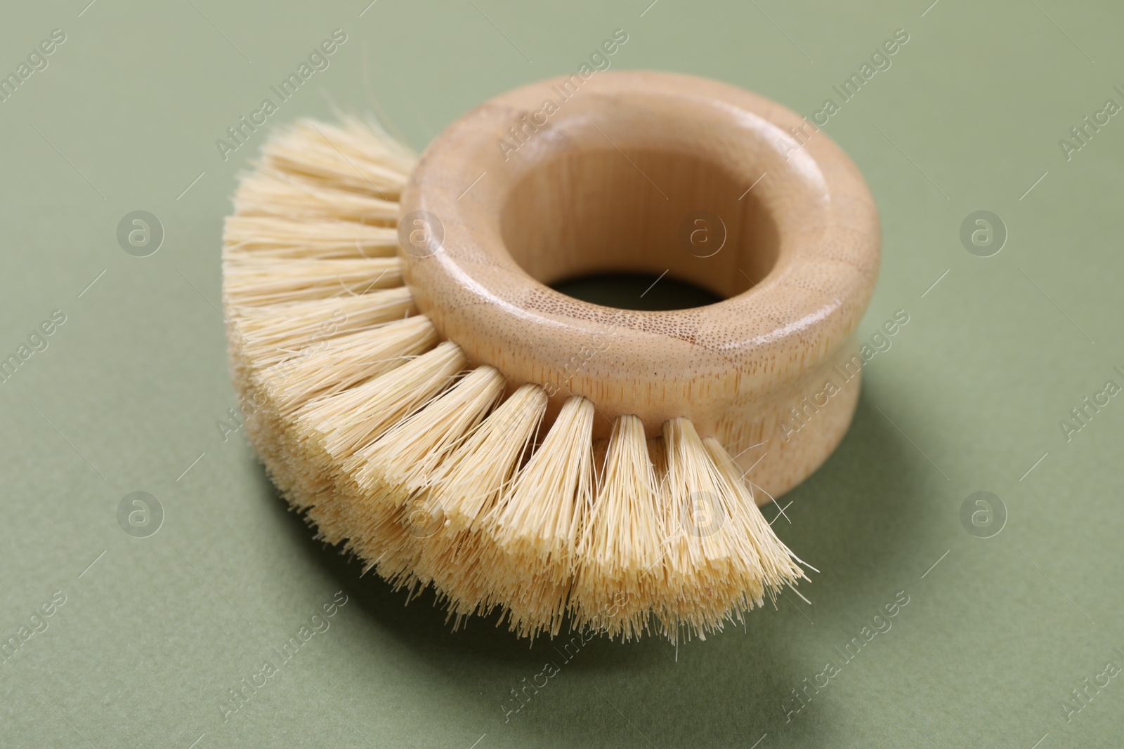 Photo of Cleaning brush on green background, closeup view