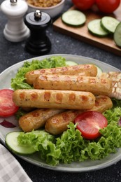 Photo of Delicious grilled vegan sausages with fresh herbs and vegetables on grey table