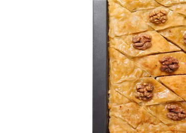 Photo of Delicious baklava with walnuts in baking pan isolated on white, top view