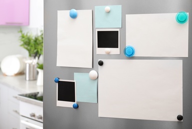 Photo of Sheets of paper and photos with magnets on refrigerator door indoors. Space for text