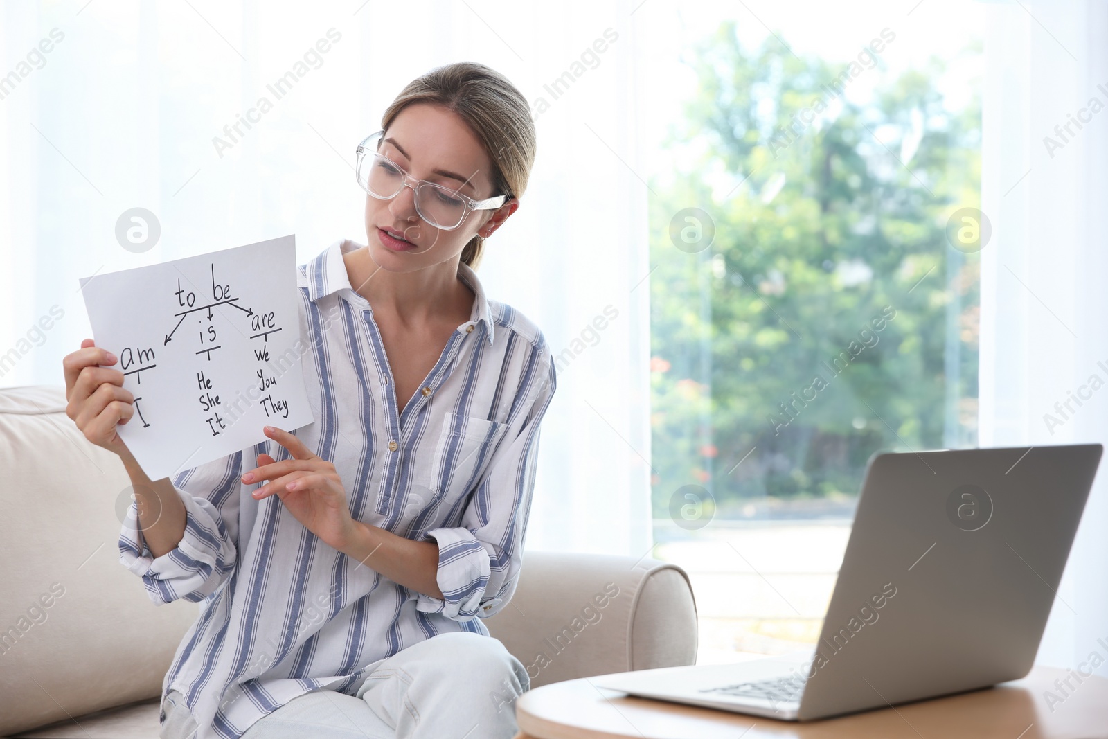 Photo of Teacher giving online english lesson. Distance learning during coronavirus quarantine, study at home