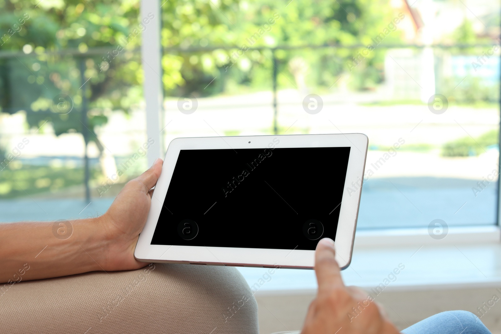 Photo of Man with modern tablet at home, closeup