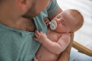 Photo of Father with his newborn son, closeup view