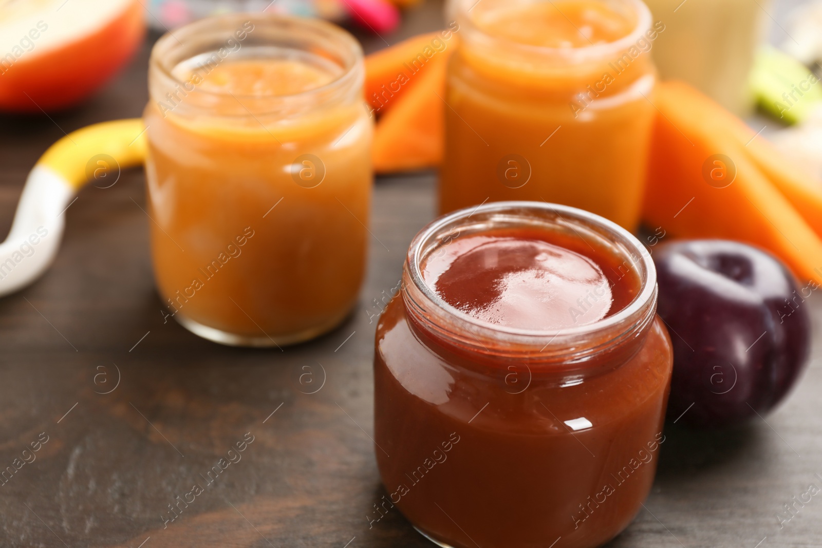 Photo of Jars with healthy baby food on table