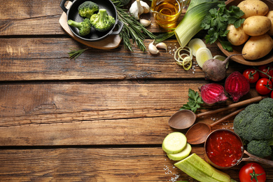 Flat lay composition with fresh products on wooden table, space for text. Healthy cooking