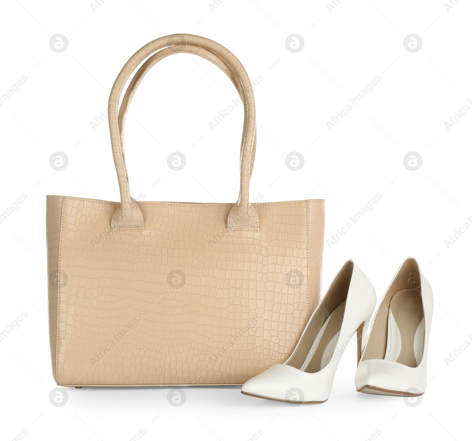 Photo of Beige women's leather bag and high heeled shoes on white background