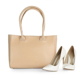 Photo of Beige women's leather bag and high heeled shoes on white background