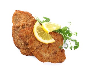 Delicious schnitzels with lemon and microgreens on white background, top view
