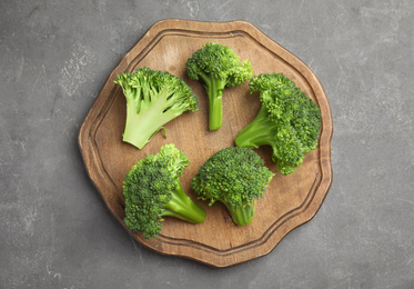 Photo of Fresh green broccoli on grey table, top view