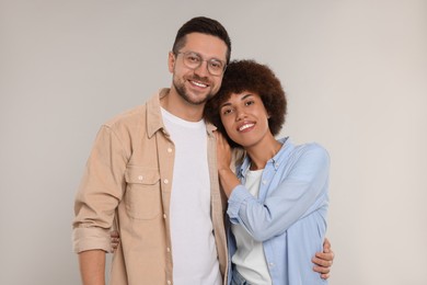 Photo of International dating. Portrait of happy couple on light grey background