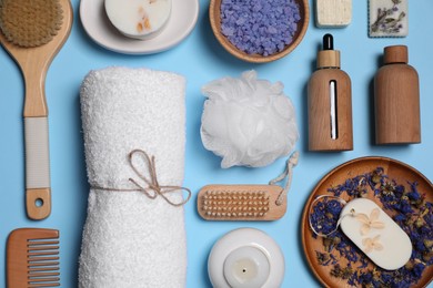 Flat lay composition with different spa products on light blue background