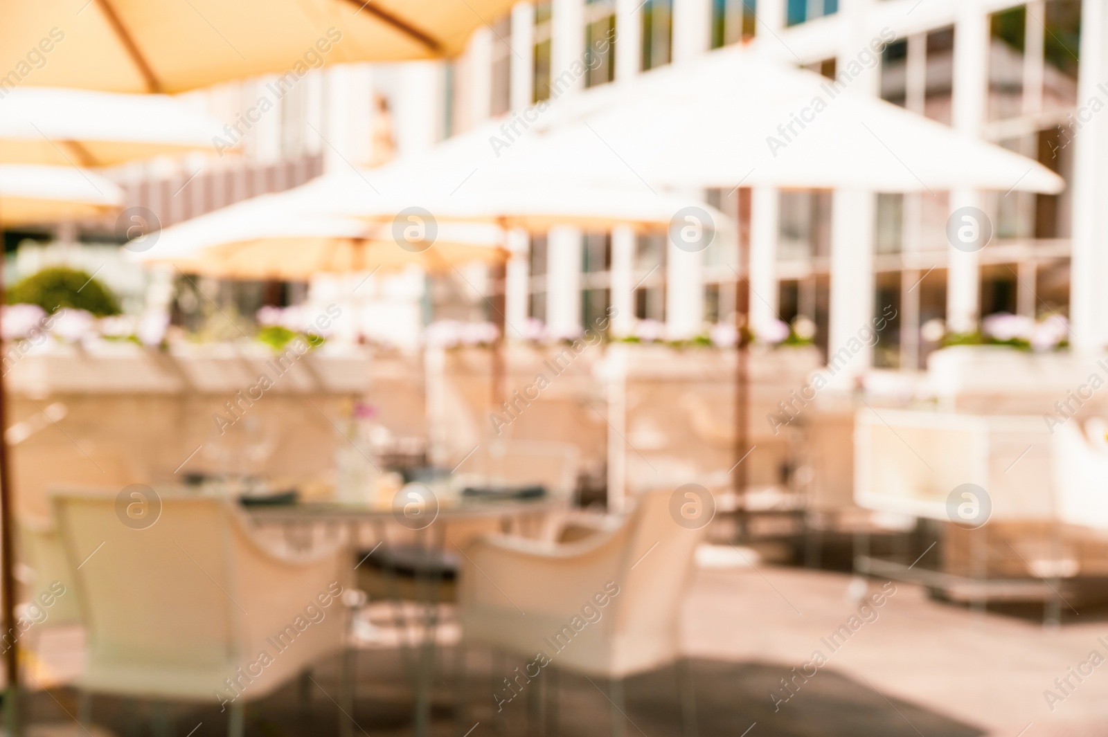 Photo of WARSAW, POLAND - MAY 15, 2022: Blurred view of cafe with outdoor terrace