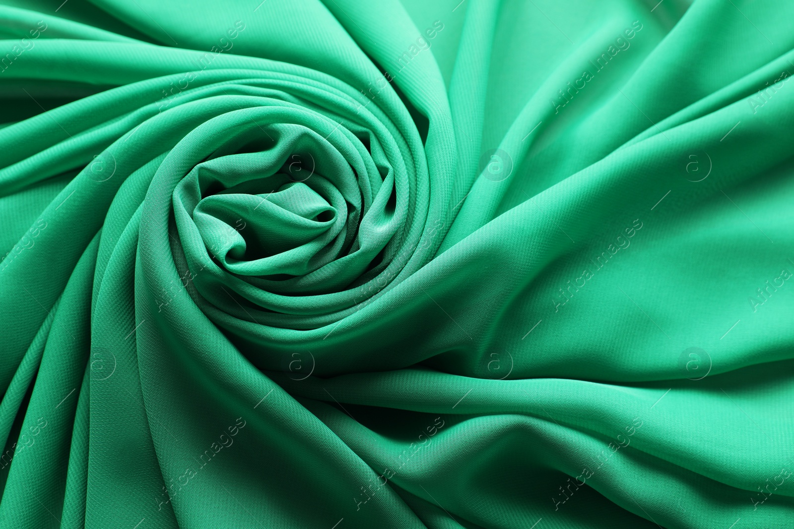 Photo of Beautiful green tulle fabric as background, top view