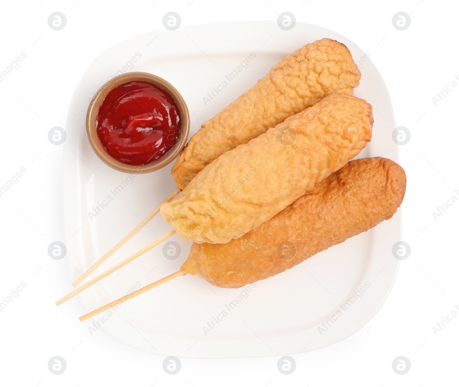 Photo of Delicious deep fried corn dogs with ketchup on white background, top view