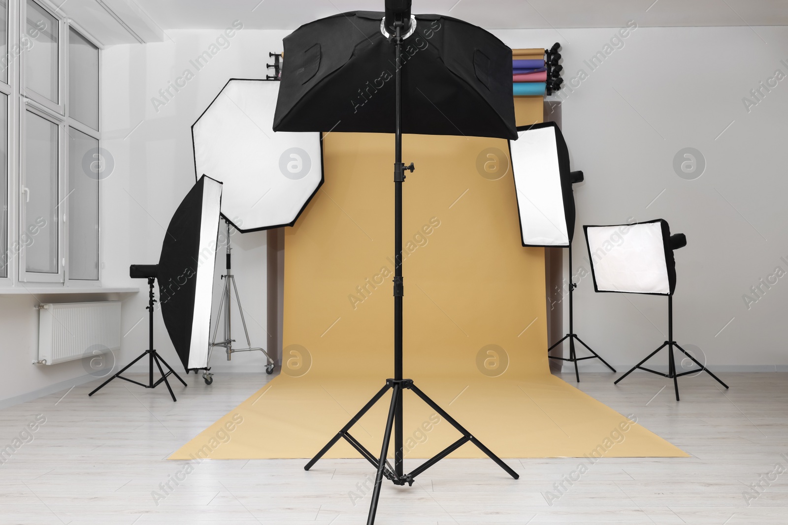 Photo of Interior of modern photo studio with professional lighting equipment