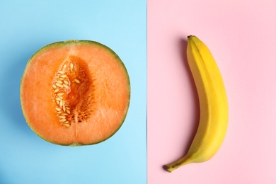 Photo of Flat lay composition with fresh banana and melon on color background. Sex concept