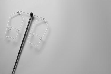 Photo of Intravenous pole on light grey background, top view. Space for text